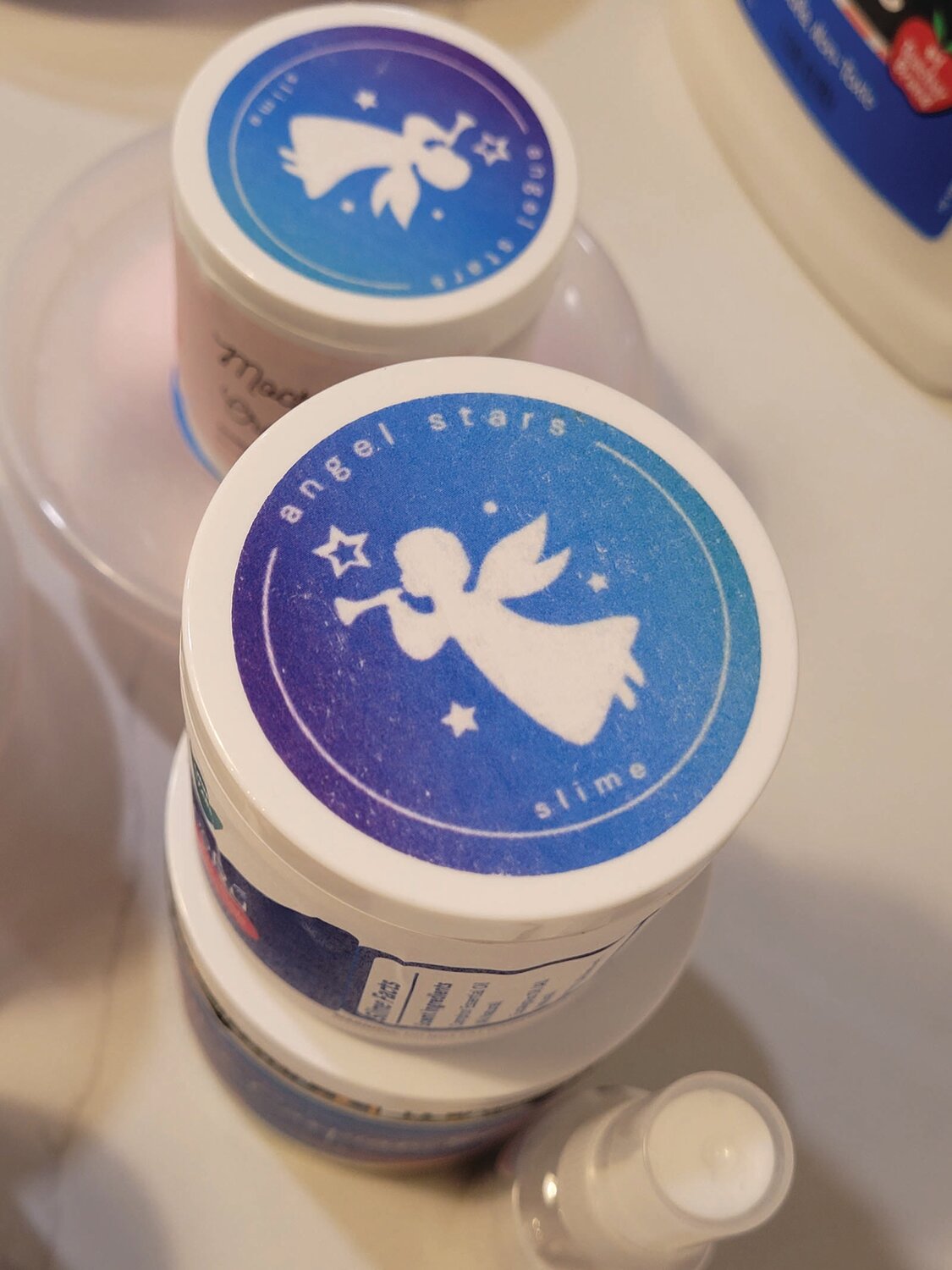 ONE-KID ASSEMBLY LINE: Penelope Santos loves making slime. Now she hopes to share it with others, selling her product online. She designed the logo (shown here) that appears on each container of Angel Stars Slime.